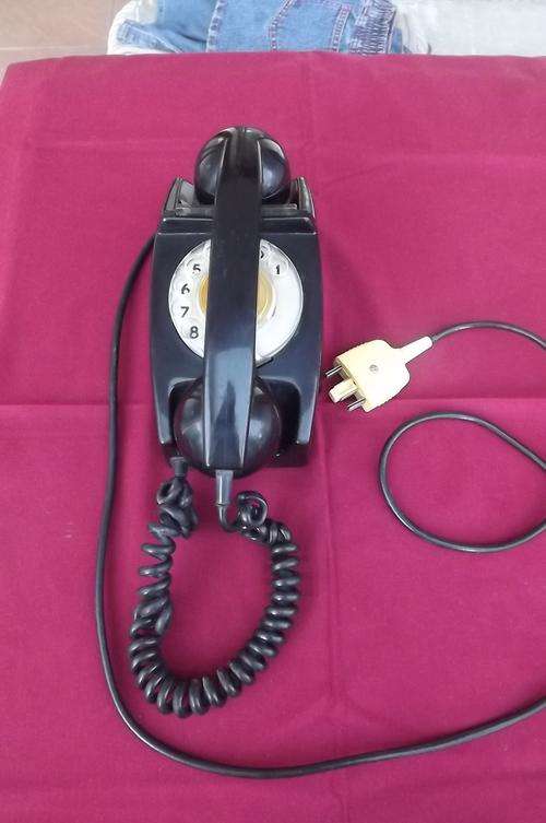 Heavy black vintage telephone with working dial.Complete and in good condition