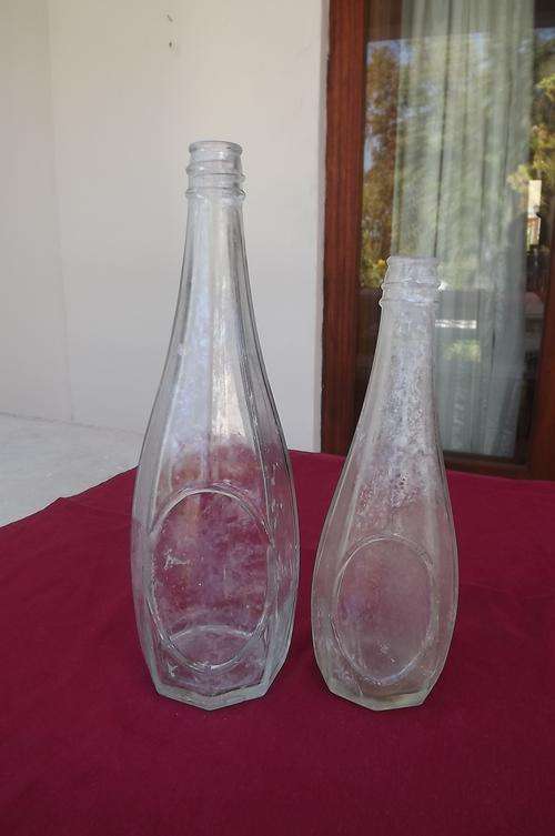 Set of antique clear glass bottles by Jones&CO SA.Large 28.5cm tall.Smaller 23cm.Numbered on bottom
