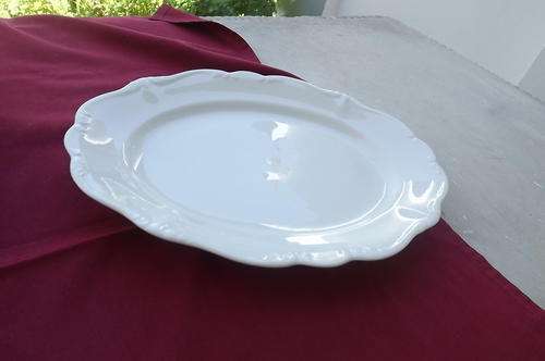 Medium vintage white porcelain serving plate with scalloped edge33 x 24.5 cm.Good condition