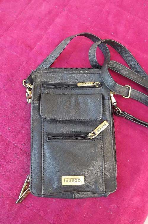 Men's handy black slingbag by Brando with storing place for everything possible.Very good condition.