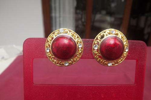 Pair of antique clip-on gold toned round earrings with 4 simulated diamond stones and red inners.