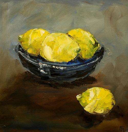 Three lemons in a blue bowl