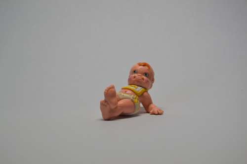 Collectable baby doll lying on back