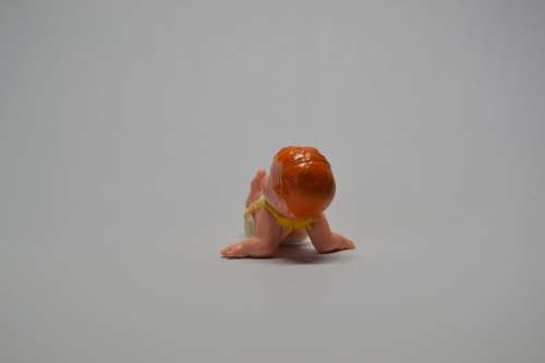 Collectable baby doll lying on back