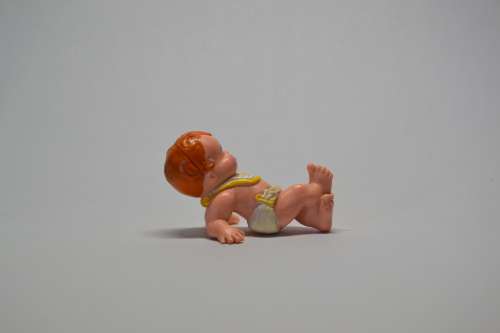 Collectable baby doll lying on back