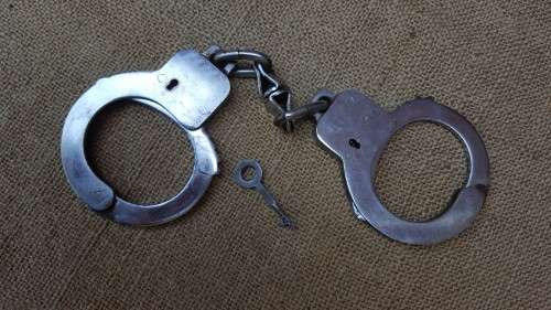 very good & well used old style used condition SAP (stamped) period hand-cuffs with key