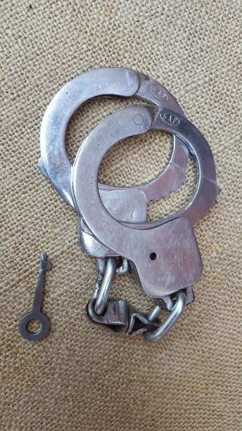 very good & well used old style used condition SAP (stamped) period hand-cuffs with key