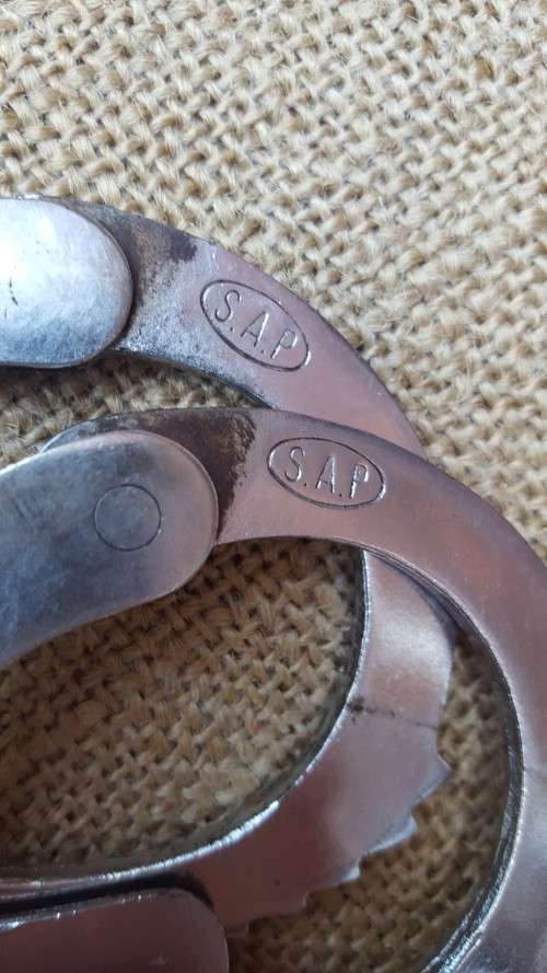 very good & well used old style used condition SAP (stamped) period hand-cuffs with key