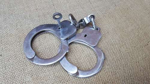 very good & well used old style used condition SAP (stamped) period hand-cuffs with key