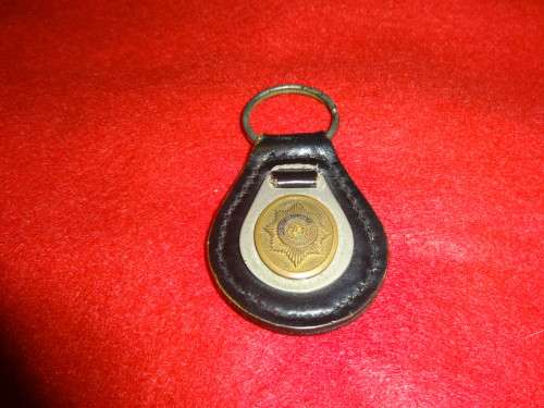 BLACK LEATHER KEY HOLDER WITH BRASS OLD SOUTH AFRICAN POLICE BADGE