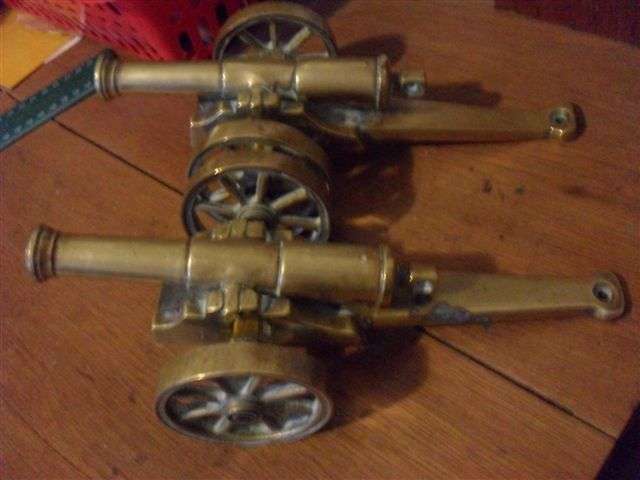 ON OFFER A PAIR OF BRASS CANNONS ......