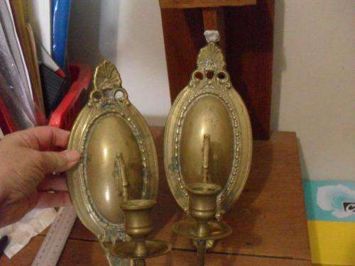 A PAIR OF BRASS WALL MOUNT CANDLE HOLDERS