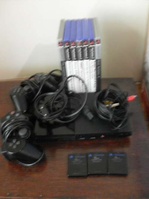 SONY PS2 CONSOLE WITH CABLES REMOTES AND GAMES