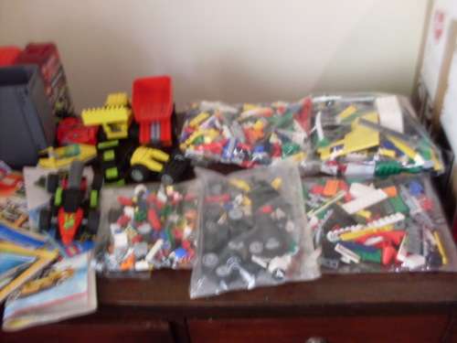 A LARGE COLLECTION OF LEGO PIECES AND BOOKLETS ETC