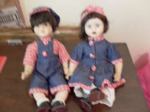 A PAIR OF PORCELAIN DOLLS HERE