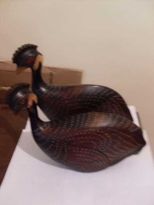 A PAIR OF LIMITED EDITION HAND CARVED WOODEN CRESTED GUINEA FOWL (FEATHERS OF KNYSNA )