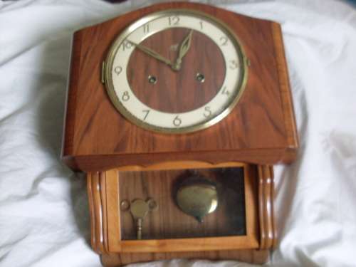 VERY UNUSUAL SHAPE WALL CLOCK CIRCA 1930`S....MAKER U. M. MULLER WITH LION LOGO
