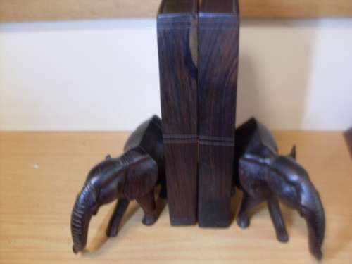 SOLID HEAVY WOODEN CARVED BOOKENDS....