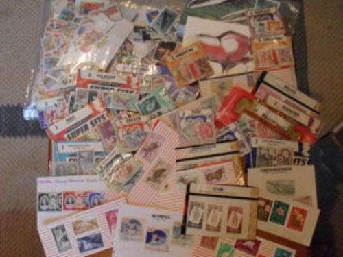 A PACKET OF WORLD STAMPS AND LOTS OF SETS OF STAMPS ETC