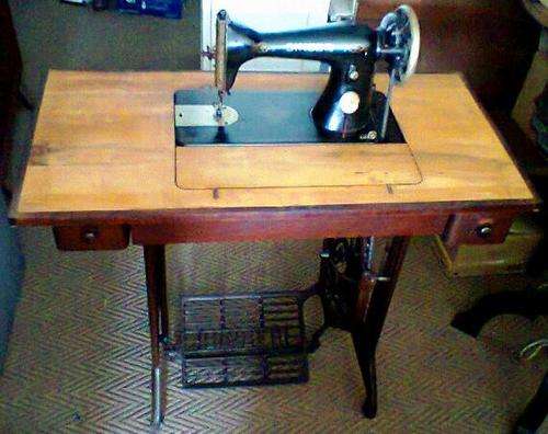 A Real Old Vintage Foot Treadle "Singer" sewing Machine in a two Draw Cabinet in working Condition.