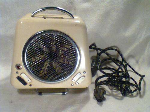 A Old Vintage 220V " Coxy Glo " Heater with fan, in good working condition.