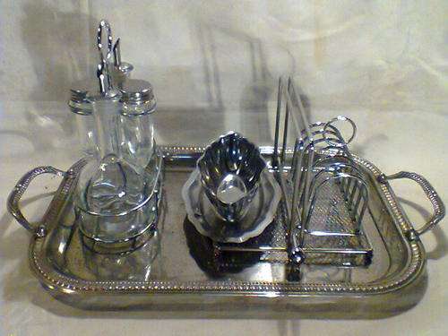 A Vintage Lot of Items, Tray with Cruet set, Toast Rack, Gravy Boat,Napkin Holder.All used condition