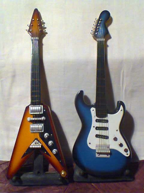 For the Man Cave to display 2 Miniature Guitars on stands Sizes: 210mm Long in Used s/hand Order