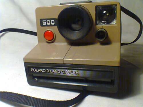 A Scarce and Rare "Polaroid 500" Land Camera with hand strap and in good used second hand condition.