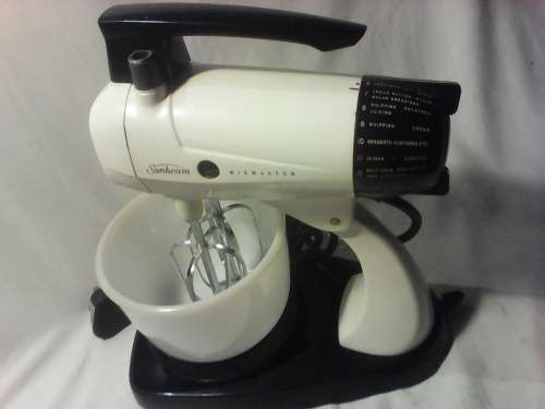 1950's vintage Sunbeam Mixmaster  on stand with milk Glass Bowl in working condition. Sold as used.