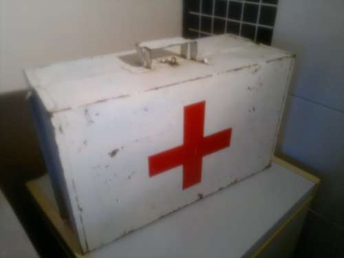 A Vintage Tin First Aid Box.In the Days when Medics were tough and had to carry heavy Equipment.
