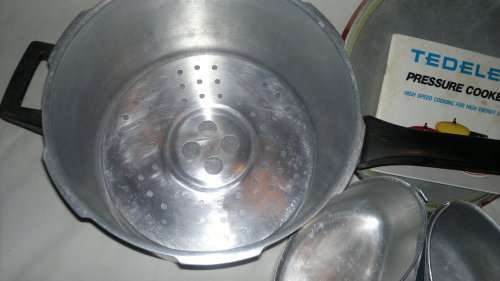 A Vintage "Tedelex" Pressure cooker with receipt book & 3 smaller pot's & defuse plate & regulator