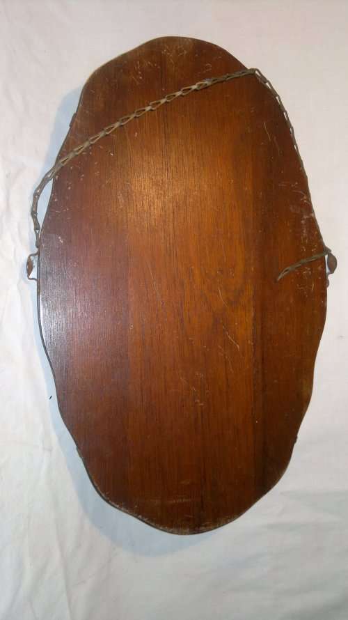 A Vintage Dressing table Beveled Mirror rigged up to hang on wall.Still has brackets plus chain on.