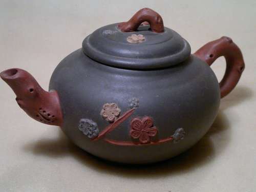A Vintage Chinese Yixing Pottery Tea pot Signed under and flowers on the side with No damage.