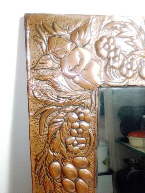 Bargain an impressive wall mirror . Hand beaten ornate copper wall mirror, 4 Angels on the corners .