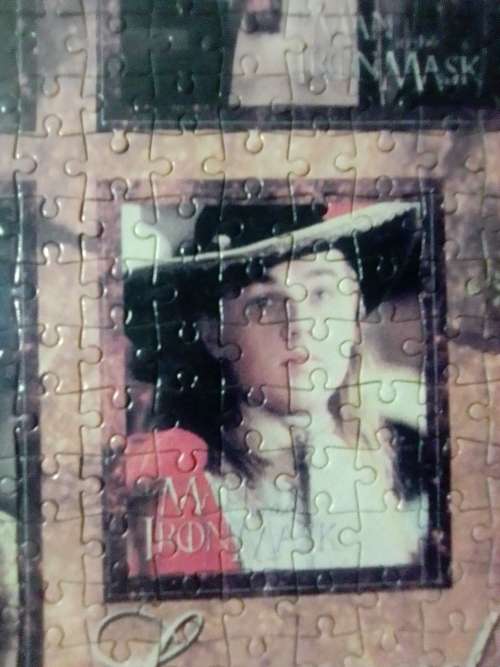 `The Man in the Iron Mask` staring Leonardo De Caprio Puzzel under glass in a solid wood frame.