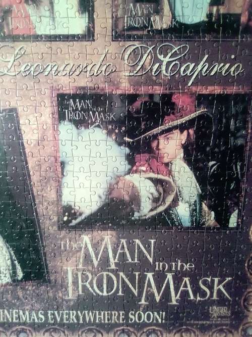 `The Man in the Iron Mask` staring Leonardo De Caprio Puzzel under glass in a solid wood frame.