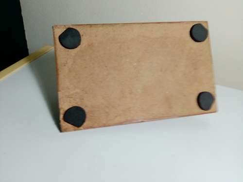 A Brass Canon with crest on Barrel, mounted on a wooden plinth with 4 feet.