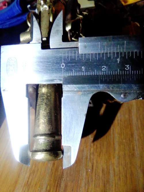 A Brass Canon with crest on Barrel, mounted on a wooden plinth with 4 feet.