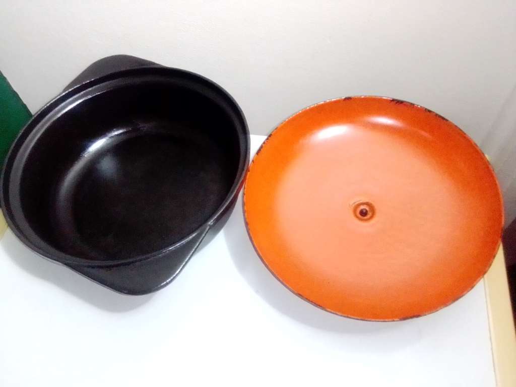 A well-used and in pristine orde, vintage Cookwell orange enameled lidded cast iron cooking pot No8.