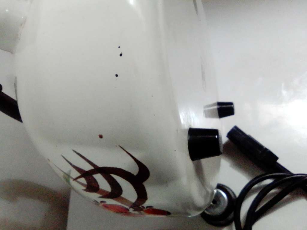 A Hendlers whistling white Enamel manual 3 footed electric 3Lt Kettle a flower motif.