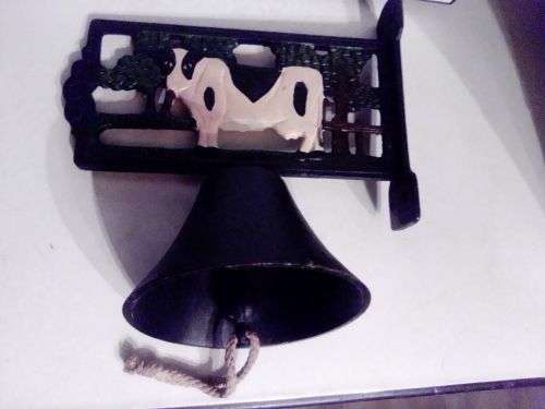 An Old Vintage very heavy Cast iron kitchen Cow Bell. It has been stored a long time.