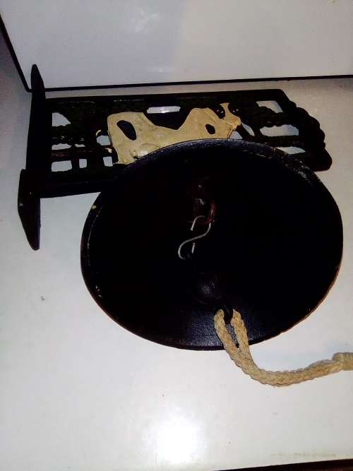 An Old Vintage very heavy Cast iron kitchen Cow Bell. It has been stored a long time.