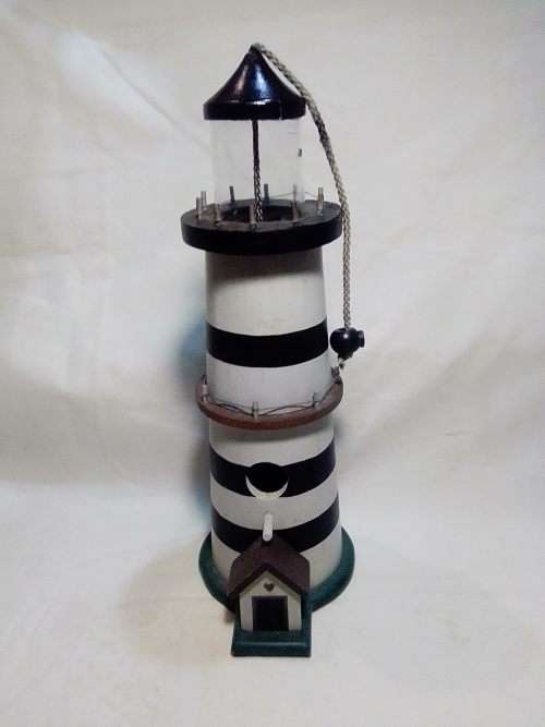 A signed `NCE` Light house bird feeder decoration or use.