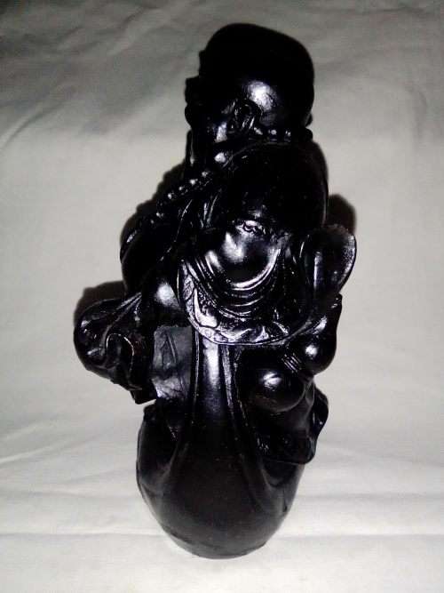 A signed black in colour ` The Laughing Buda ` very heavy and clean. Size 10cm wide x 14.5cm Tall