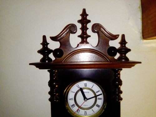 A clean dark wood working Quarts `Blessing` Wall Clock. In good condition.