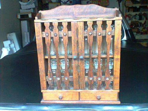 A Very Old OAK Spice rack with 12 vintage glass containers. Postage R59- + 2% Insurance.