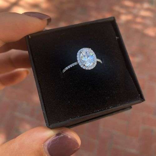 The S925 Sterling Silver 1.25 Ct. Clear Oval Cut Halo Engagement Ring