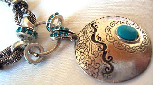 Lovely Tibetian silver round pendant with 3 turqouise hoops