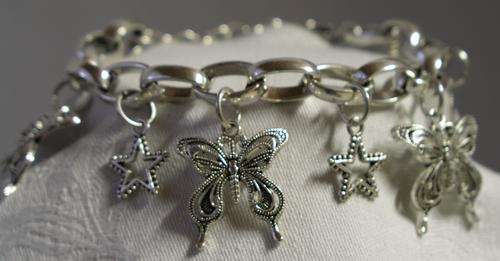 Lovely Tibetian silver charm bracelet with butterflies, stars and a leave