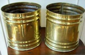 A PAIR OF BRASS POT HOLDERS